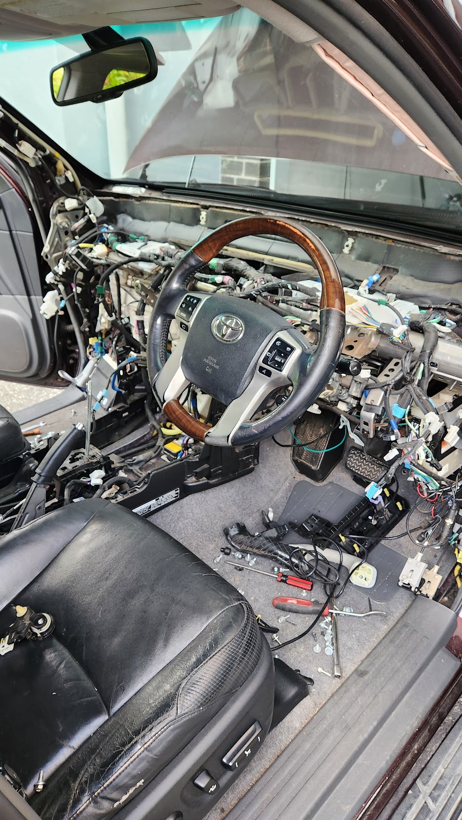 Toyota with the dashboard stripped back to the wiring